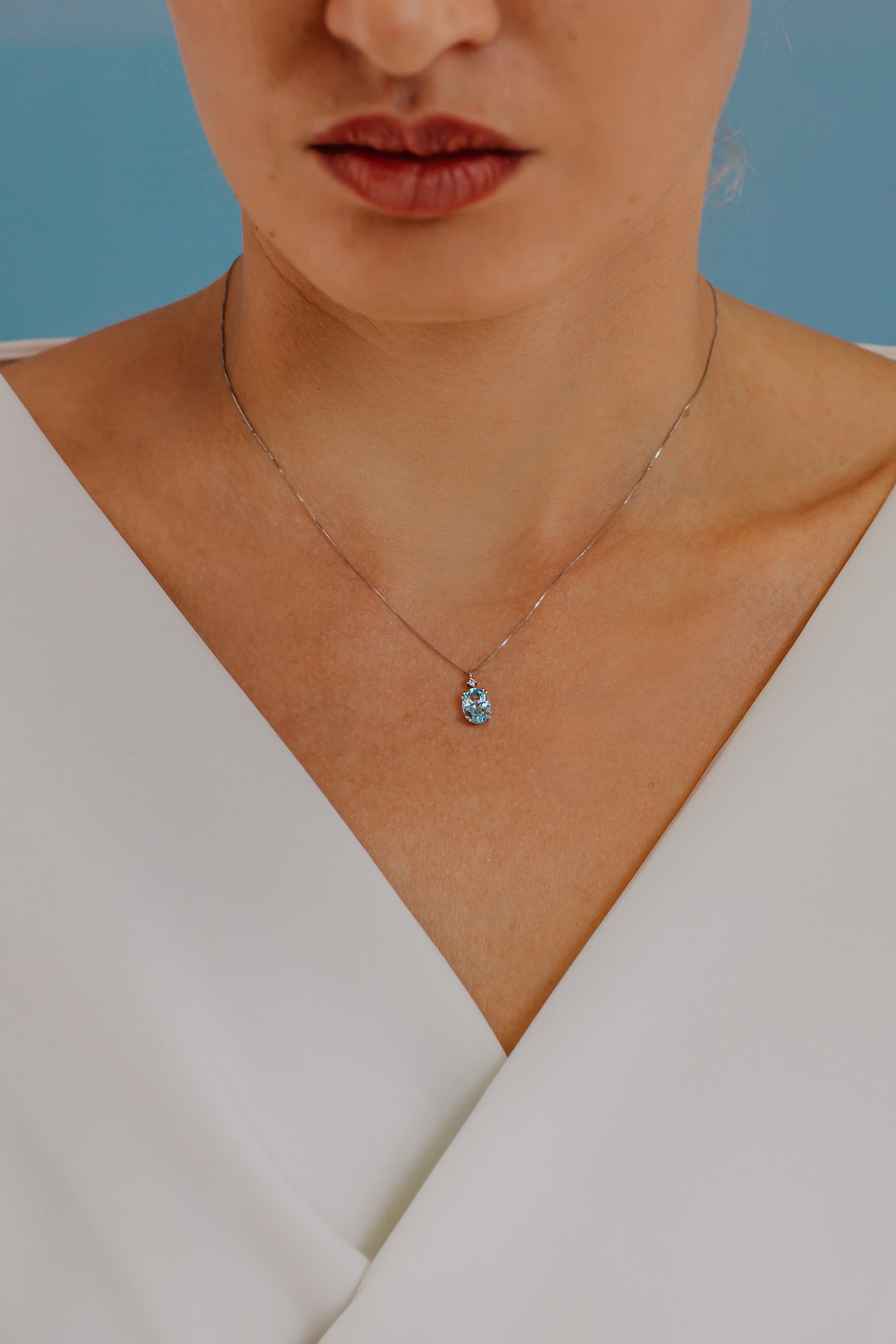 Comete ketting in goud en ovale blauwe topaas GLB1206