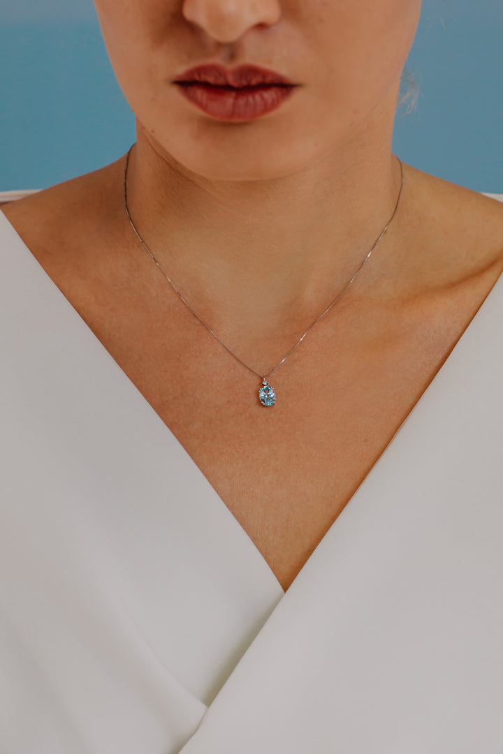 Comete ketting in goud en ovale blauwe topaas GLB1206